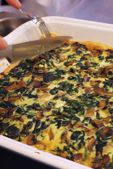 Spinach and mushroom quiche. Culinary school recipes of of world-famous dishes.